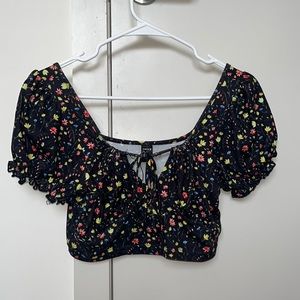 Cute blouse from Shein in a size small, black with yellow, red and blue flowers